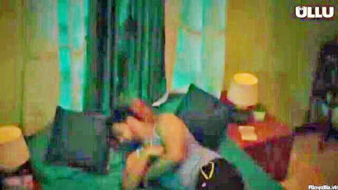 Desi couple in intimate embrace, man kissing woman's neck on bed