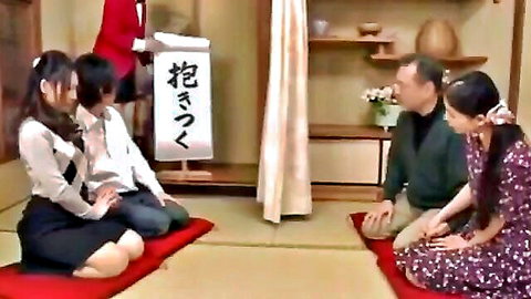 Japanese wives and husbands sit on tatami mats with wife husband signs in swinger wife swap setup