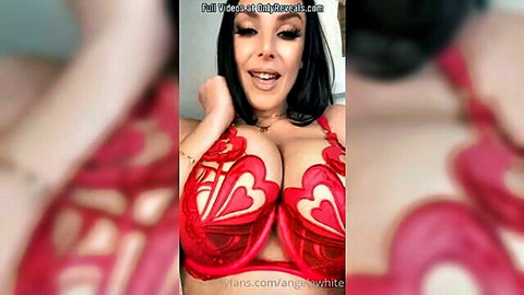 Brunette with massive tits overflowing red lace bra pushes cleavage smiling seductively