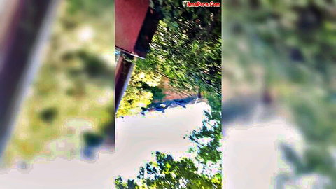 German woman in green dress at Gardaland theme park, outdoor upskirt view