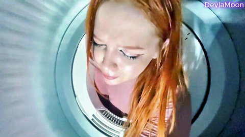 Redhead stepmom stuck in washing machine, teasing cleavage from above POV
