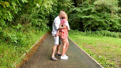Cherry Kiss in passionate outdoor embrace with lover on forest path