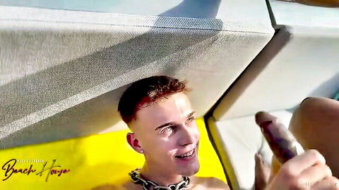Smiling twink holds big black cock in sunny outdoor scene from Black and White