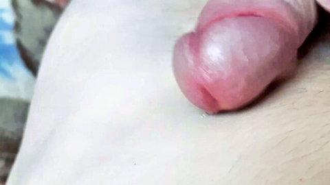 Closeup of big uncut erect cock with shiny pink glans and glistening precum