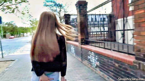 Sandra's blonde hair blowing in wind, walking away in black top and short white skirt outdoors