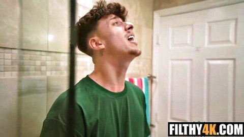Curly-haired guy in green shirt moaning in ecstasy in steamy bathroom POV
