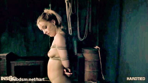 Restrained blonde in ropes exposing breasts, pregnant belly visible