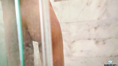 Curvy brunette teen big ass nude showering behind steamy glass door