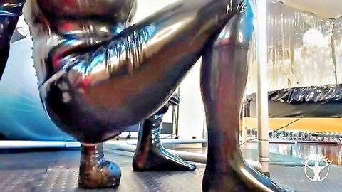Blonde amateur in shiny latex catsuit squatting by pool
