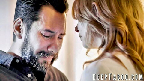 Bearded mature man gazes intensely at young redhead beauty in taboo close-up stare
