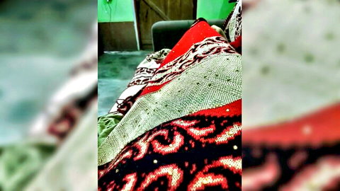 Hot__nenchi in red patterned Indian attire on bed, seductive pose