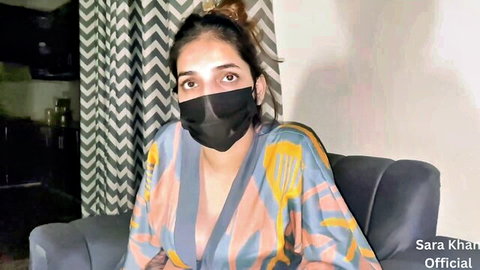 Sara Khan in open robe and mask, teasing cleavage solo