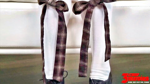 Seductive legs in white stockings with plaid bows and black high heels