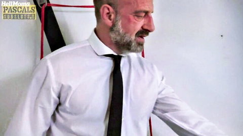 British maledom in suit dominating mature sub in BDSM scene