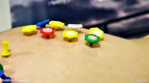 Femdom BDSM group spanking scene with colorful pins on bare skin