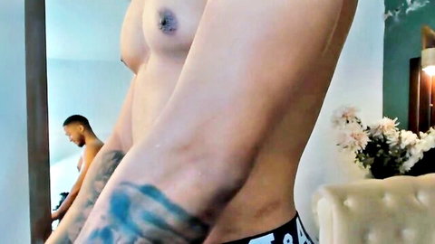 Sexy shirtless Latin man in underwear, lean muscular body with arm tattoo