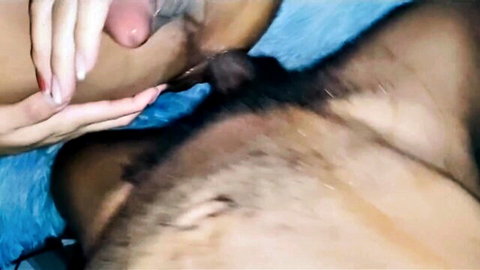 Pale hands stroking large erect black cock in steamy close-up
