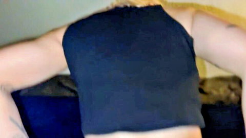 Amateur woman in black tank top bending over, teasing view from behind