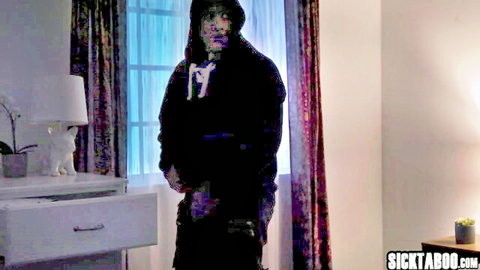 Hooded man in black hoodie stands mysteriously in bedroom with lamp and curtains