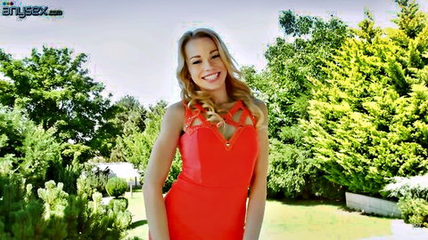 Blonde Rebecca Black in sexy red dress smiling in garden
