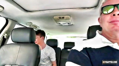 Older daddy in sunglasses smirks at submissive young Asian twink in car backseat