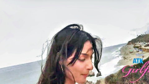Cute long-haired brunette in seductive profile by ocean, car sex tease