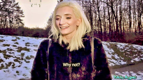 Blonde woman in hoodie smiles outdoors in snow for Public Agent pickup