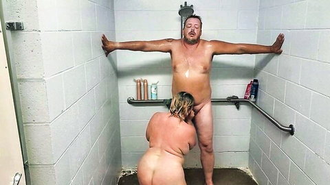 Chubby blonde wife squats nude behind mature husband rimming his ass in shower