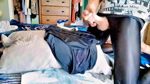 Amateur babe in shiny black leather pants teases foot near blue panties on messy bed