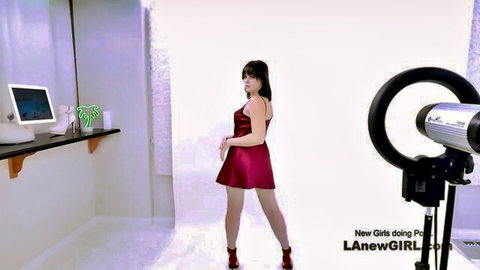 Brunette teen in sexy red dress posing seductively in studio