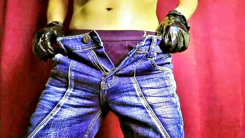 Muscular guy in jeans and black gloves teases big bulge in purple underwear