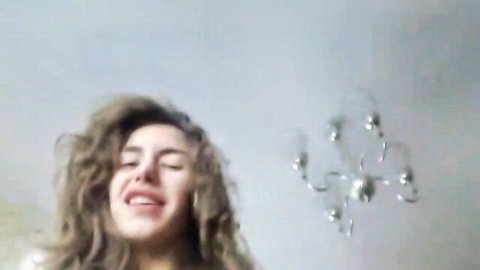 Cute curly-haired beauty smiling ecstatically in anal pleasure scene