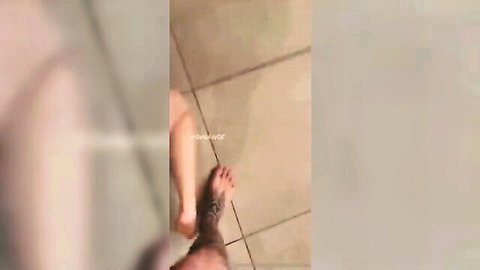 Brunette woman teasing with tattooed foot in POV shot