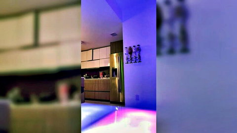 Blurry modern kitchen interior with purple lighting and gold fridge in softcore tease