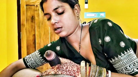 Indian woman in green embroidered blouse holding thick purple dildo with bangles