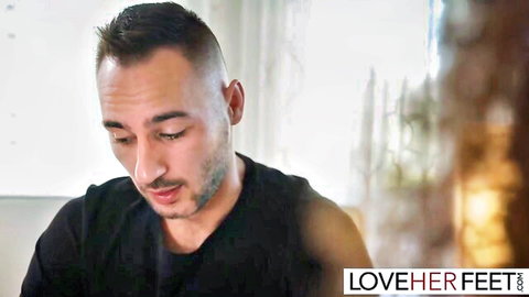 Handsome man with fade haircut gazing down intently in foot fetish preview