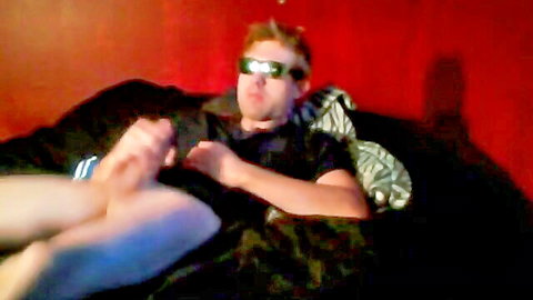 Young redhead masturbating in bed, bare feet and sunglasses, solo amateur