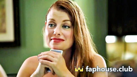 Sexy redhead teasing with cleavage while holding cards