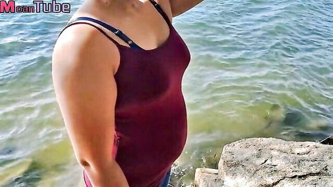 Vilashini pregnant Asian woman in maroon tank top by lake, side profile allure