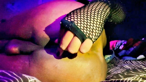 Fishnet gloved hand spreads thick tanned ass exposing pink anus and butt plug base