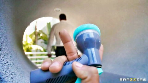 Jessica Sodi holds scrubber teasing Scott Nails from behind in outdoor scene