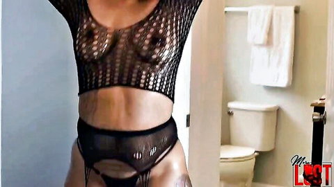 Curvy ebony babe exposes big tits nipples and shaved pussy in crotchless fishnet lingerie