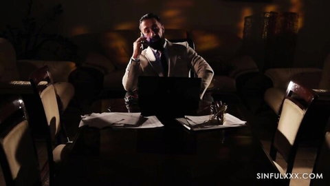 Mugur in stylish suit on phone call, office domination vibe