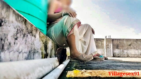 Villagesex91 Indian wife in traditional salwar kameez, sitting outdoors with legs visible