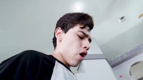 Young handsome guy with open mouth moaning in ecstasy during stepmom blowjob