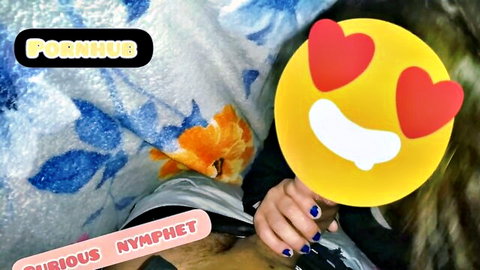 Delicious nymphet hand holding yellow heart-eyes emoji mask with Pornhub watermark on blue towel