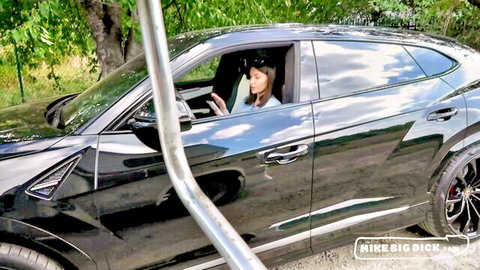 Seductive brunette MILF in sunglasses teases from black Lamborghini Urus car