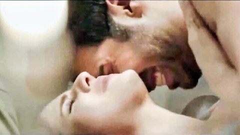 Bearded South Asian man passionately kissing woman's lips intensely closeup