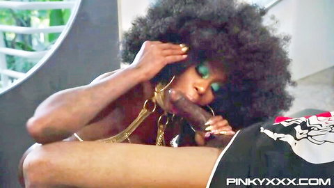 Ebony babe with huge afro deepthroats massive black dildo while topless showing big tits