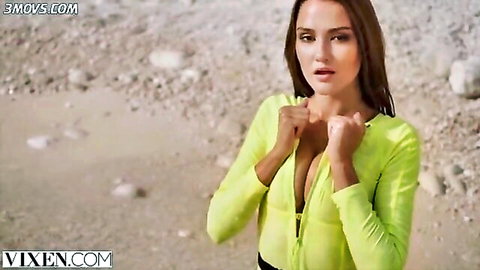 Sonya Blaze in sexy yellow top with deep cleavage on beach